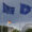 The EU, German and NATO flag fly backdropped by the Reichstag building that houses the Bundestag (lower house of Parliament) ahead a ceremony to mark Germany's 70 years in NATO in Berlin, on July 9, 2025. (Photo by Odd ANDERSEN / AFP)